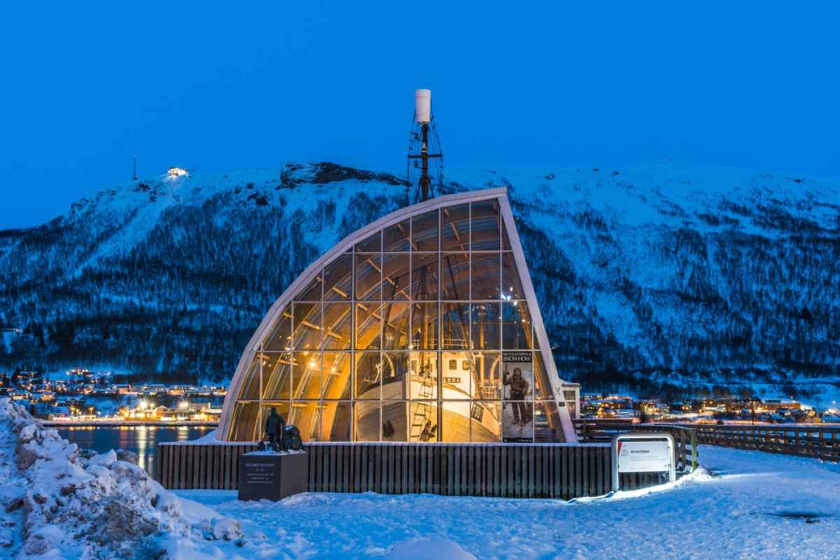 MS Polstjerna Sealing Vessel displayed inside a glass building in Tromsø at night.
