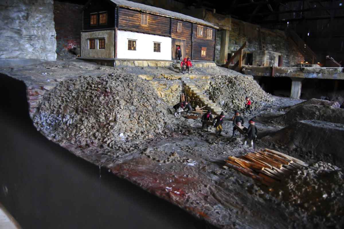 Roros Museum Miniature model of a historic mine scene inside a museum exhibit, showing workers, buildings, and rocky terrain.