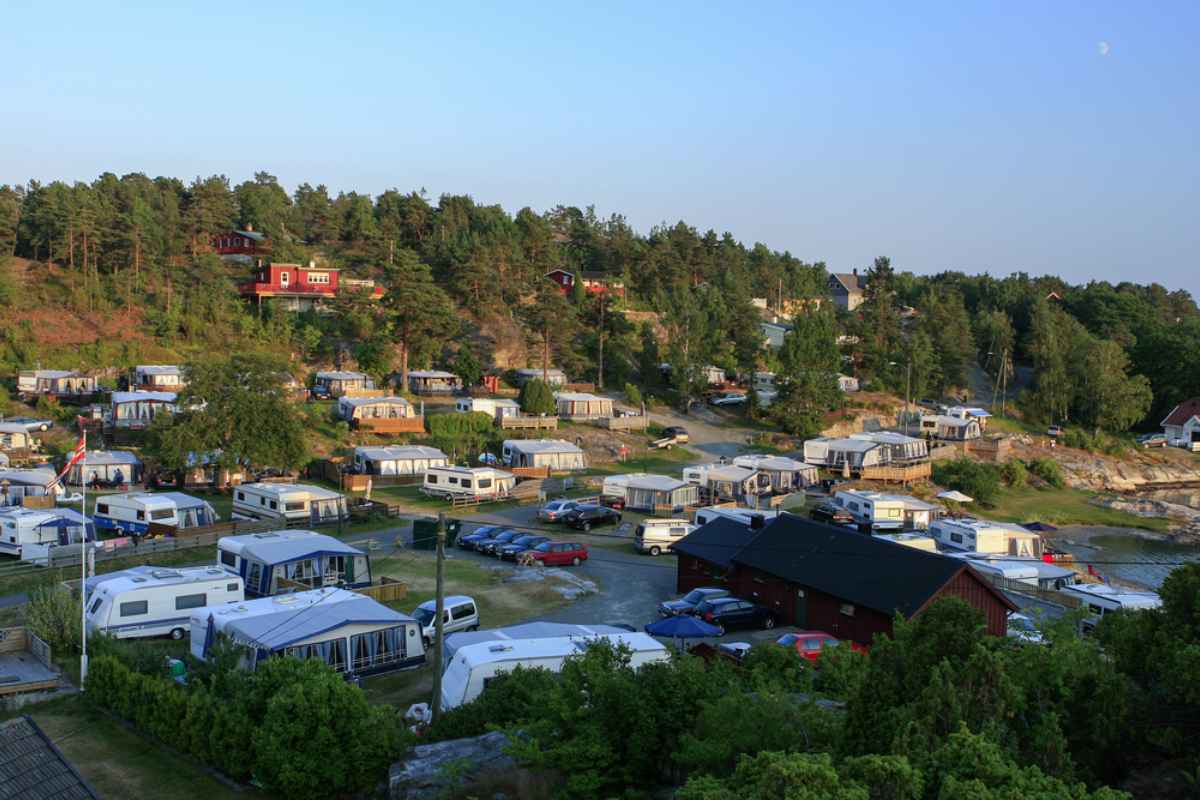 Camping in Kristiansand Aerial view of a camping site with caravans and cabins surrounded by trees in Kristiansand