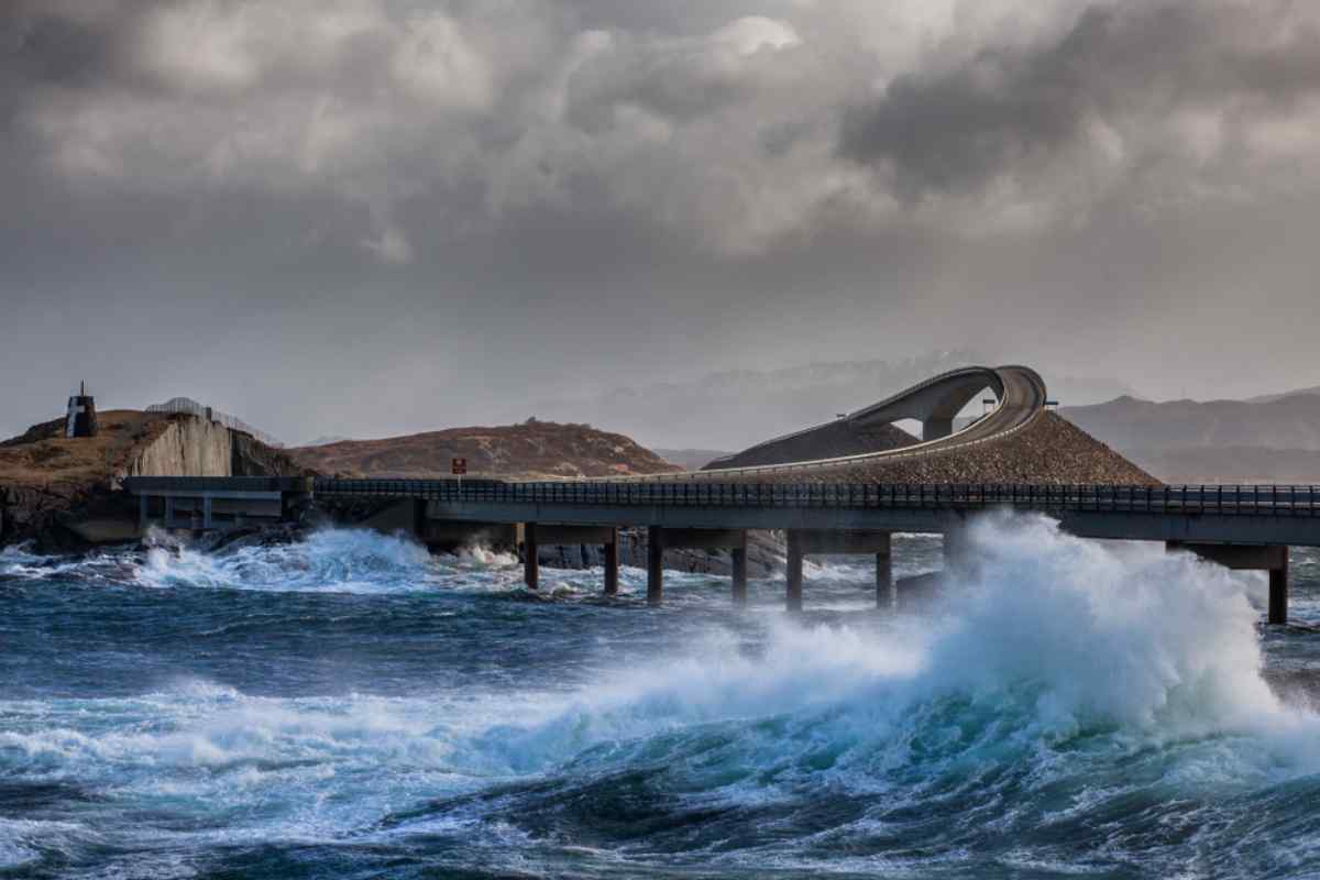 Norway’s Atlantic Ocean Road Storm waves crash beneath the Storseisundet Bridge on Norway’s Atlantic Ocean Road, dramatic surf and brooding sky over the curving causeway.